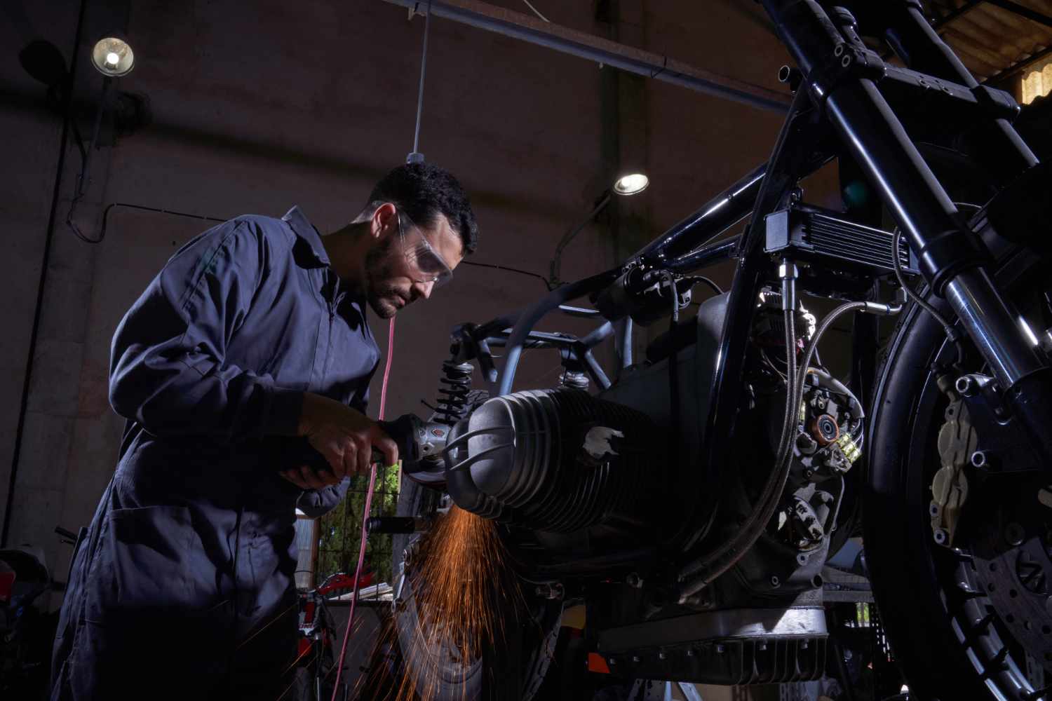 man-repairing-motorbike-in-garage-resize.jpg
